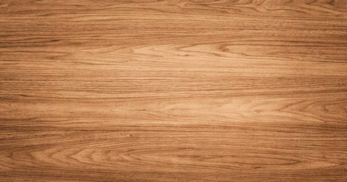 Close-up of teak wood grain showing natural golden-brown color and distinctive texture
